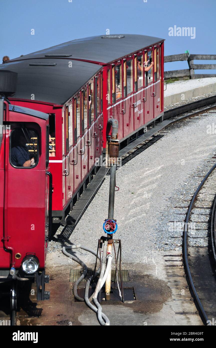 The Schafberg Railway train is a gauge cog railway in Salzkammergut. The train leading from St Wolfgang im Salzkammergut to Schafberg summit Stock Photo