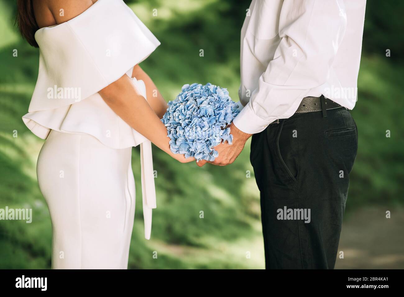 Bride And Groom Holding Hands Standing In Forest, Cropped Stock Photo ...