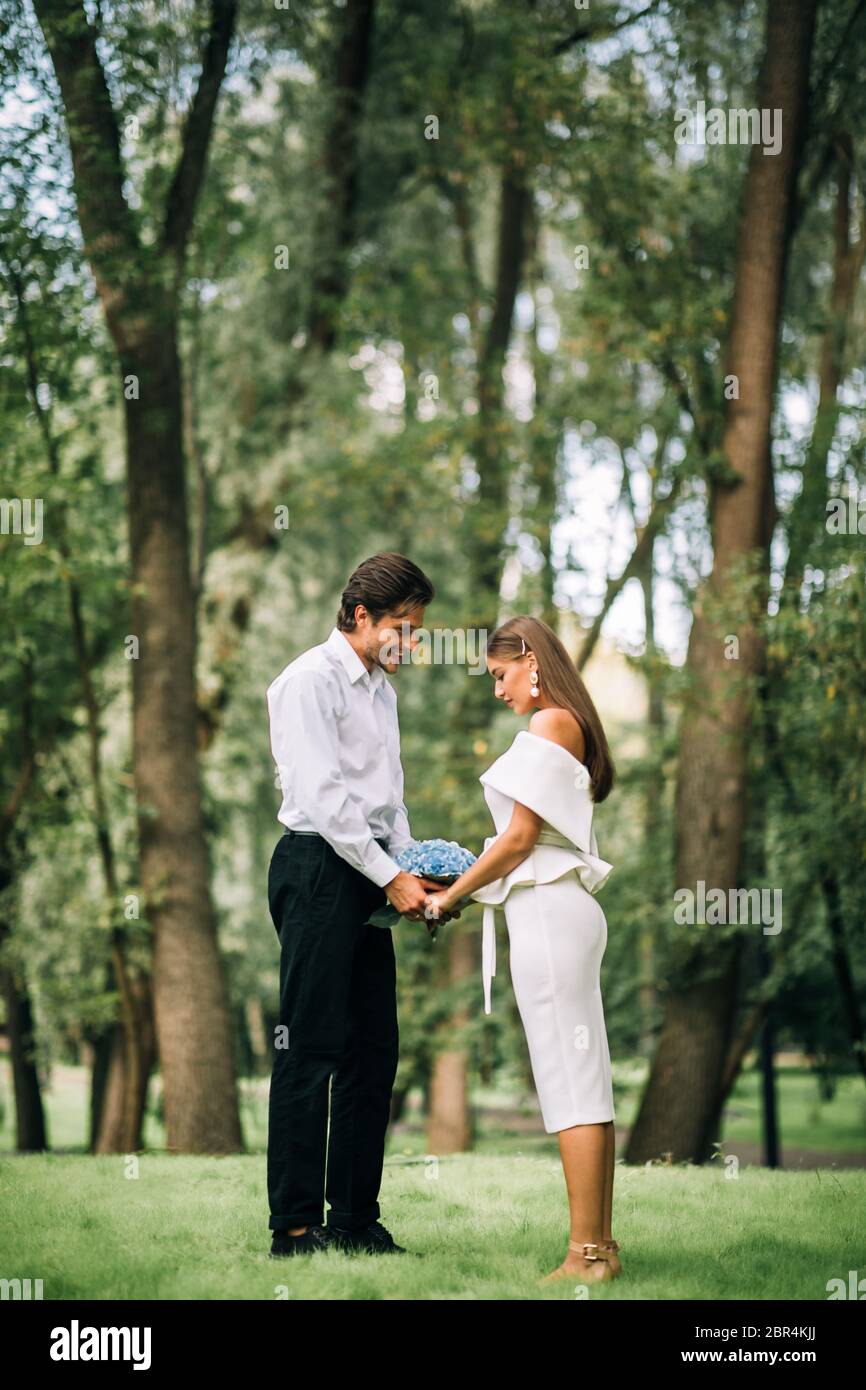 Bride And Groom In Love Holding Hands Standing In Park Stock Photo - Alamy