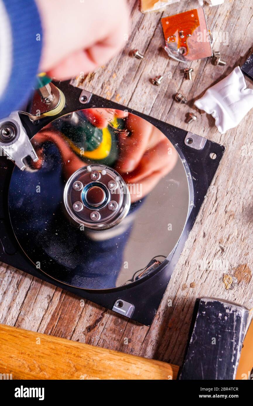 A man breaks a computer using locksmith tools. The concept of hacking ...