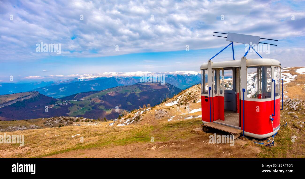 old cable way lift gondola cab abandoned in peak panorama of Monte Baldo mountain near Malcesine in Italy . Stock Photo
