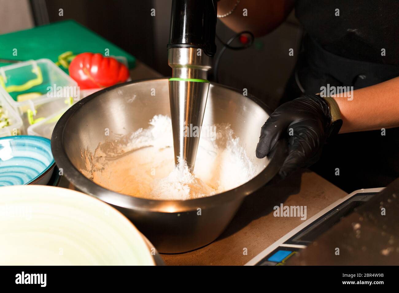 Chef making cheese mix for cheese pancake at restaurant. Blender whips the cottage cheese