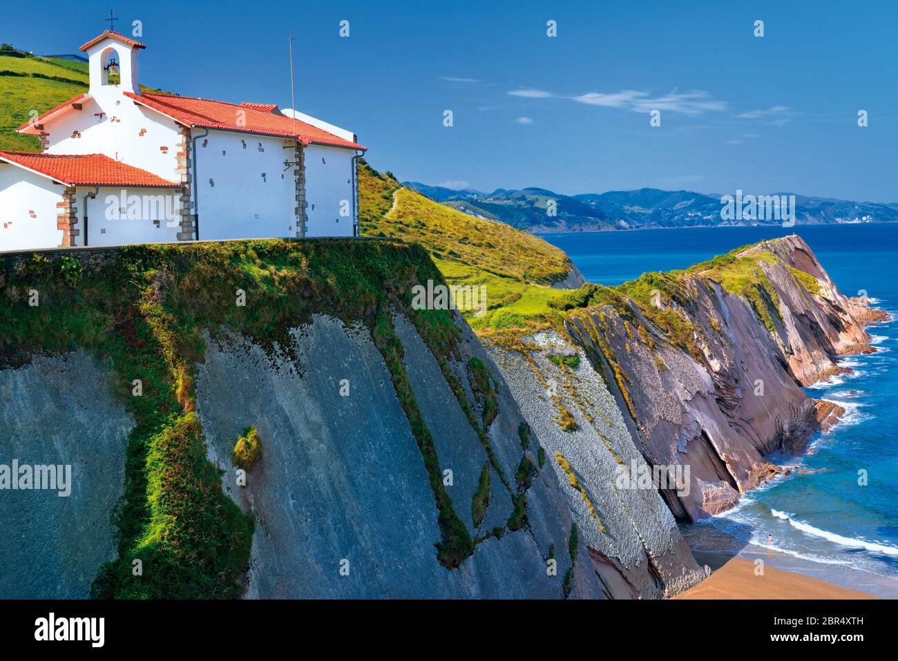 Viewpoint to wild coast with high cliffs and white washed chapel on the top (Zumaia) Stock Photo