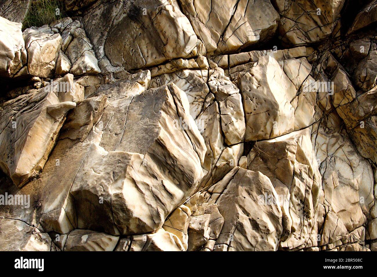Close up of weather torn, layered and cracked surface of Marble Rocks