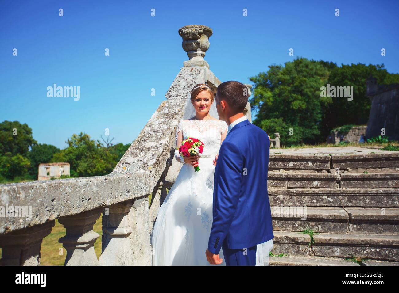 Bride and groom in the park kissing. wedding in nature green forest ...