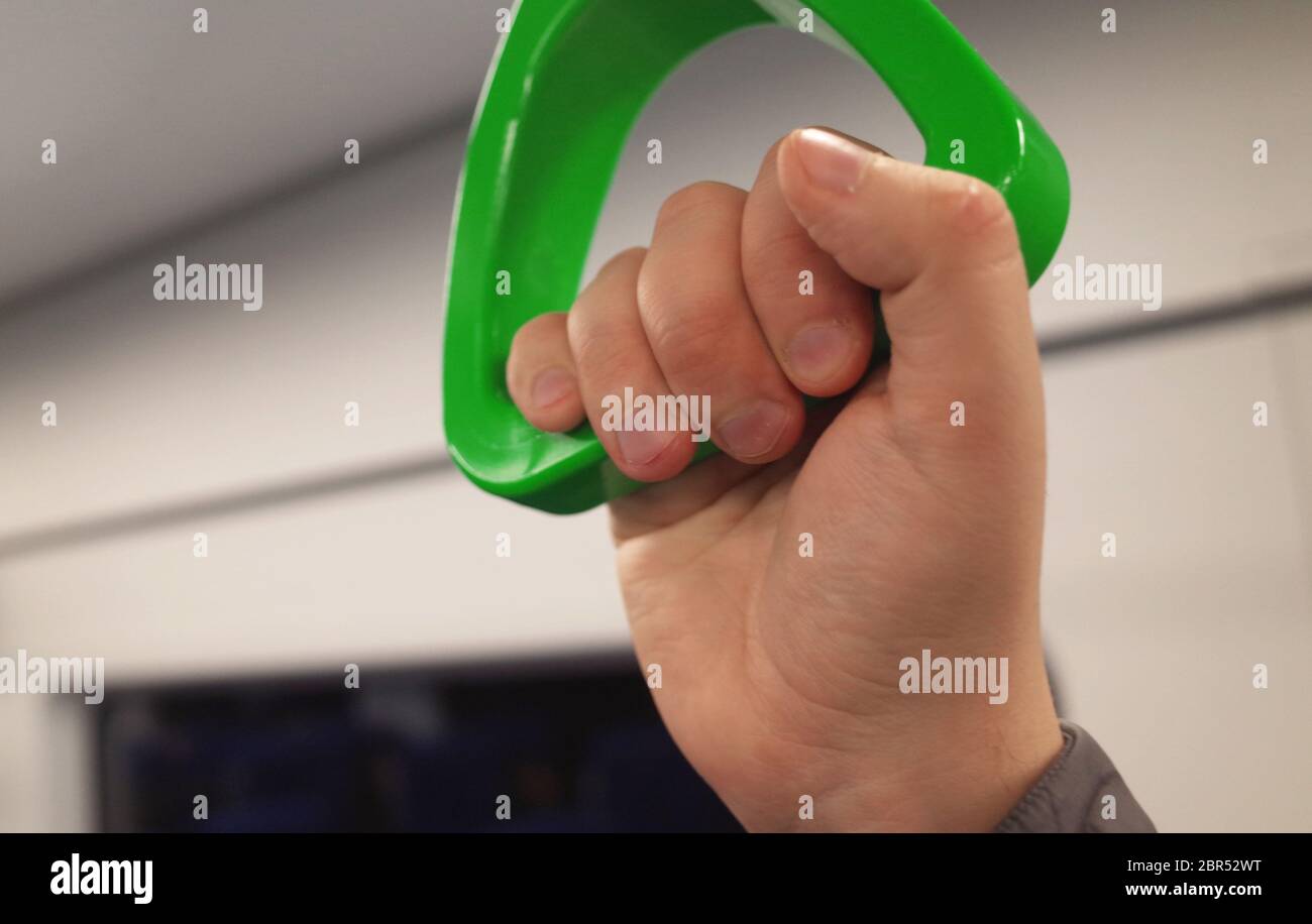 Green hanging hand-rail in public transport Stock Photo - Alamy