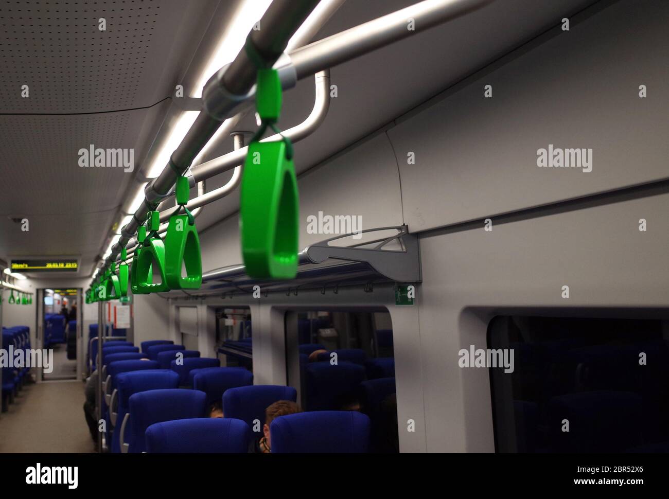 Green hanging hand-rail in public transport Stock Photo - Alamy