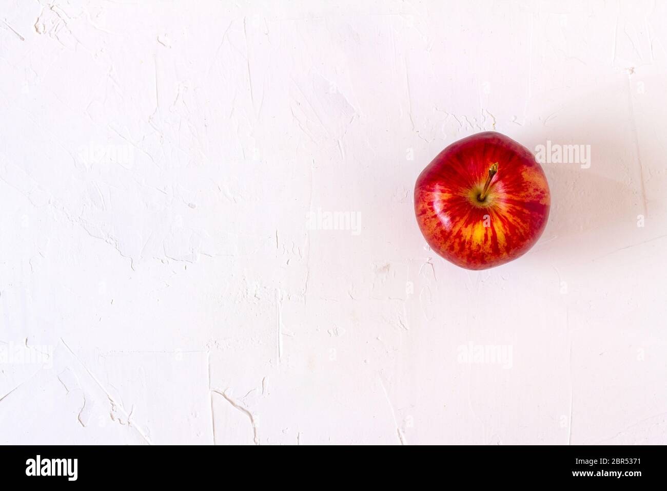 Red Apple on white table. Stock Photo