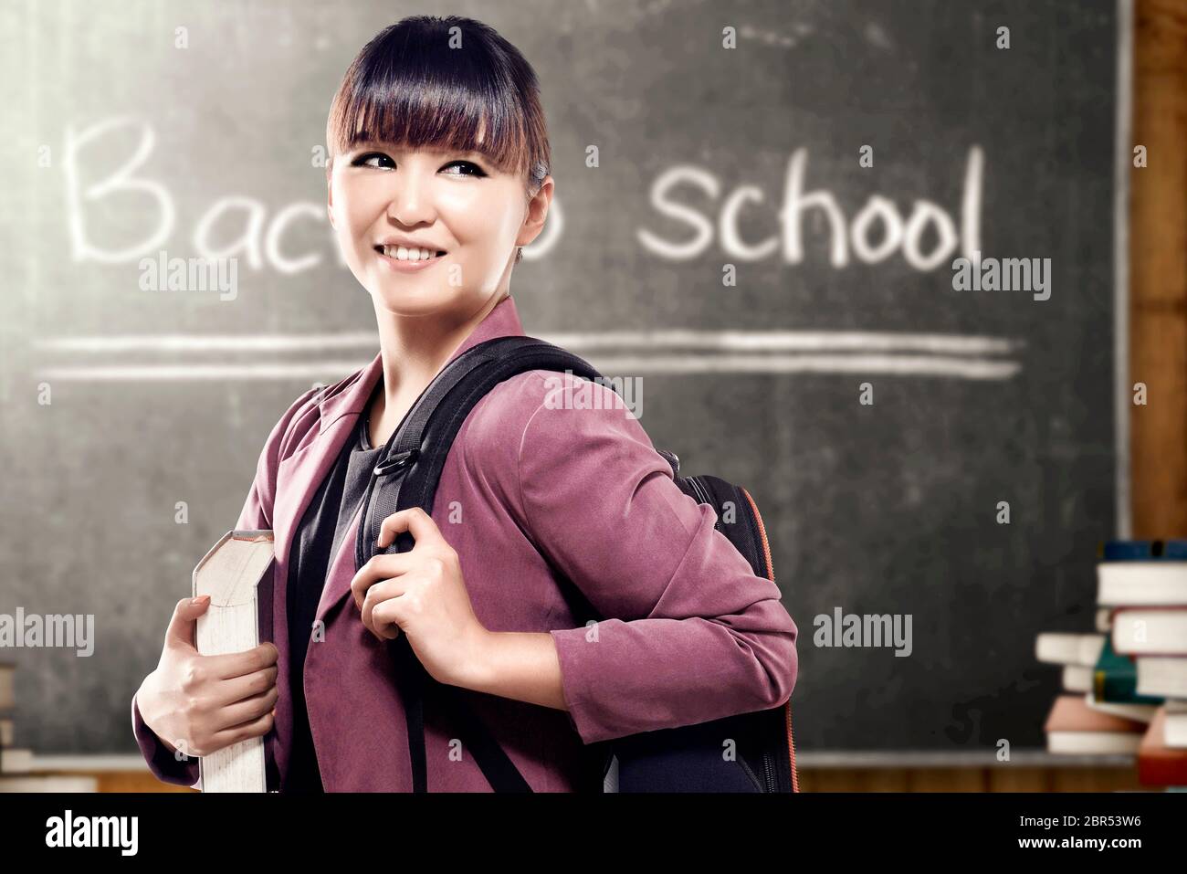 Asian student woman with backpack carrying book standing and look back ...
