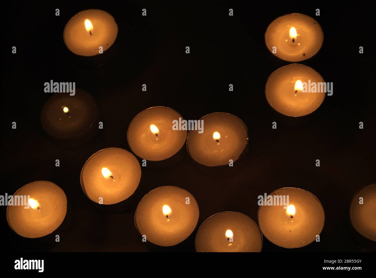 Candles flame close up on a black background Stock Photo - Alamy