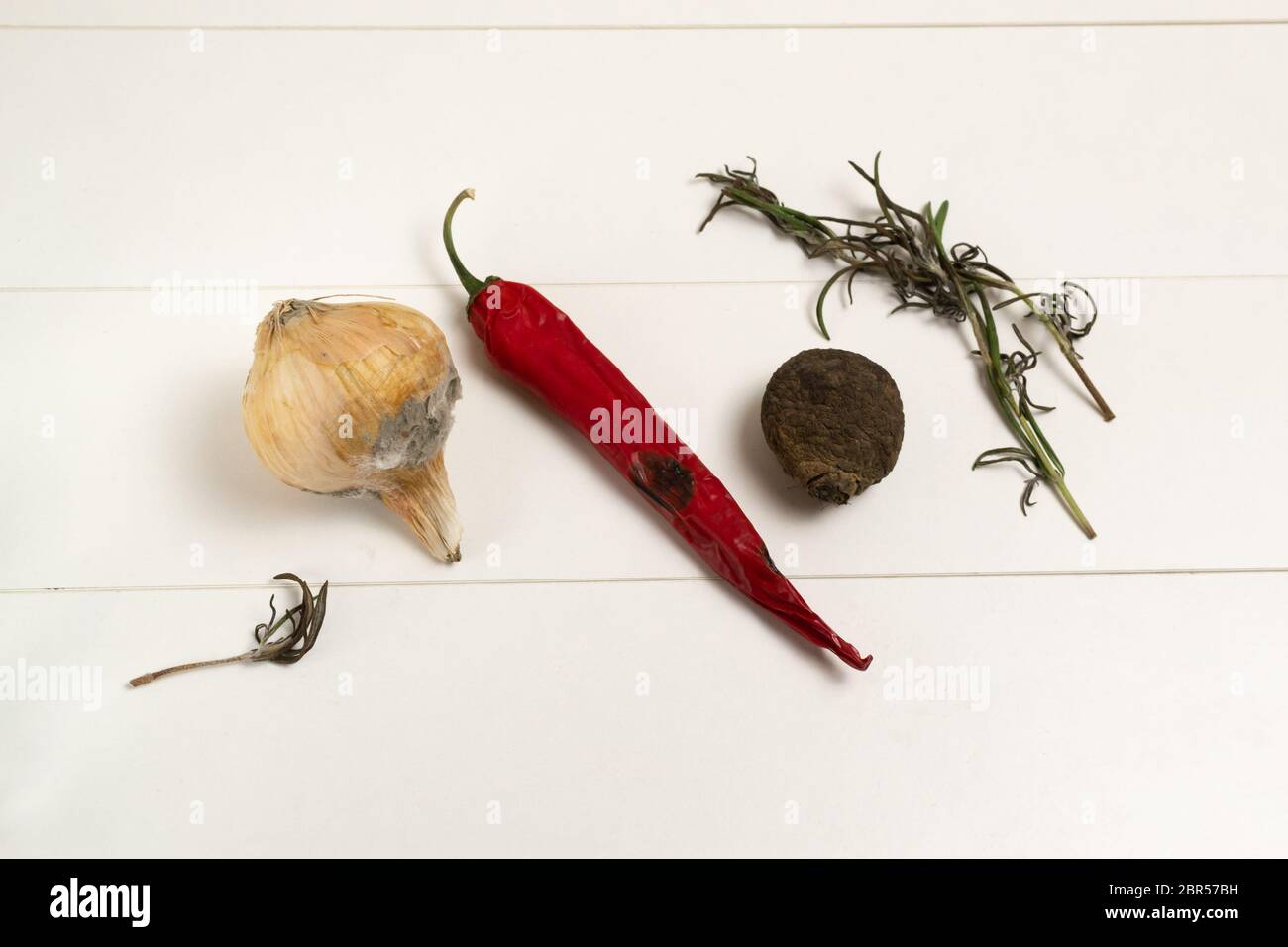Rotten onions and red peppers, dried rosemary and beets. Horizontal orientation Stock Photo