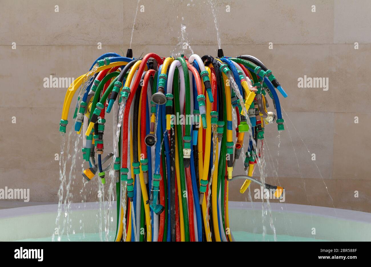 fountain made of lots of various garden hoses Stock Photo Alamy