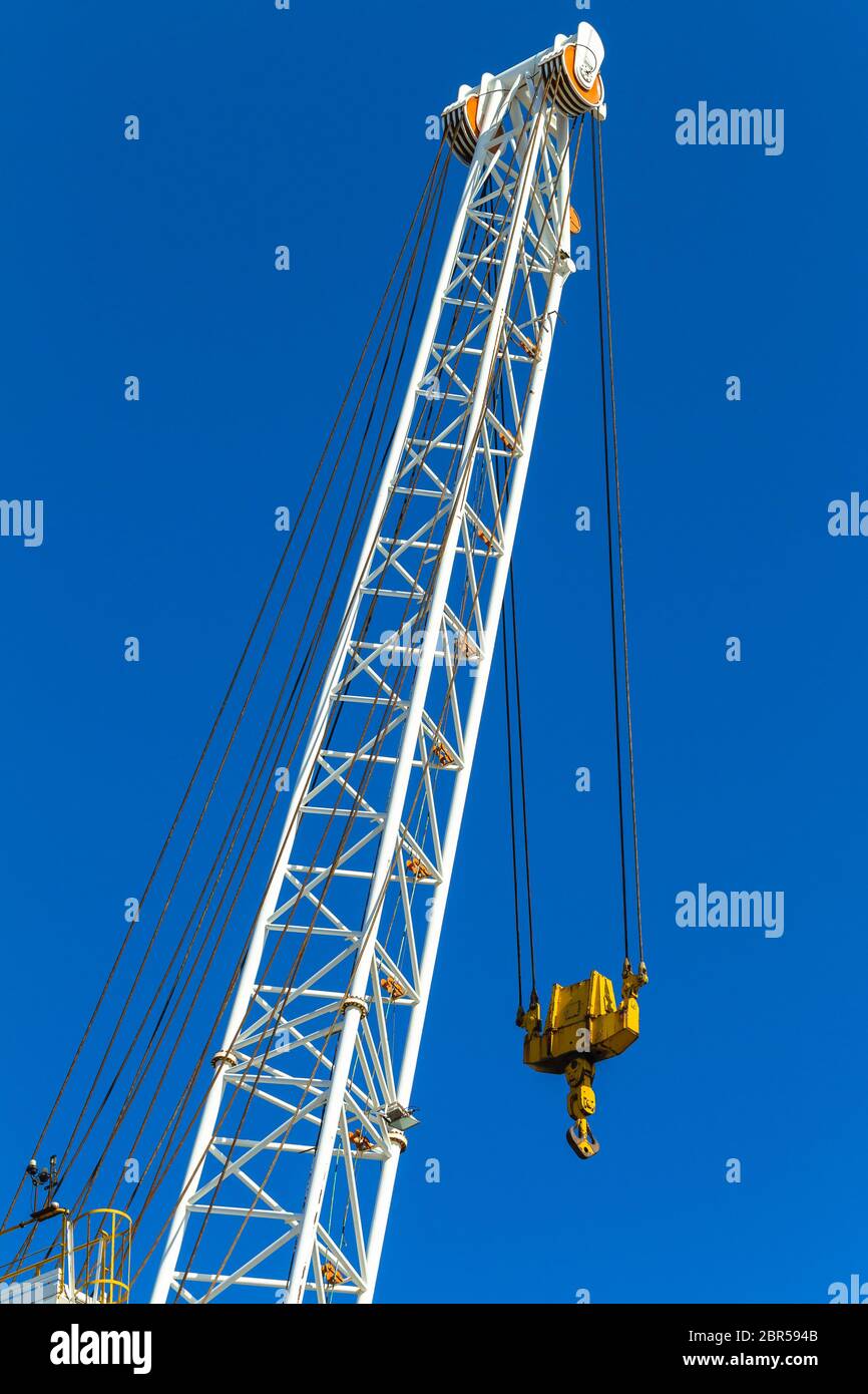 Crane arm lifting machine with cables dual pulleys to hoist hook Stock