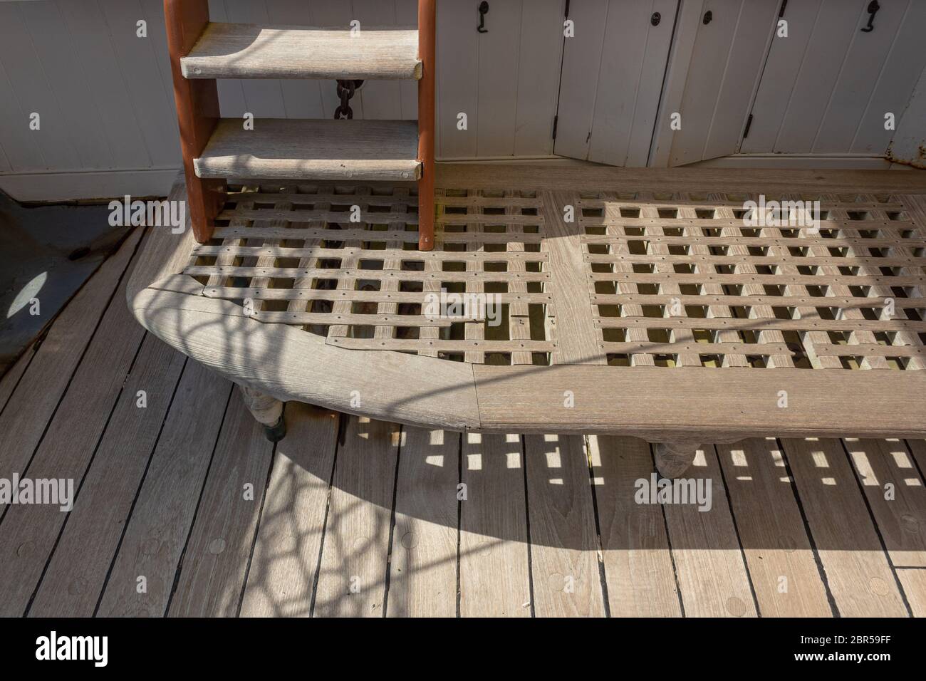 Teak boat decking and drain board, ladder on old sailing ship