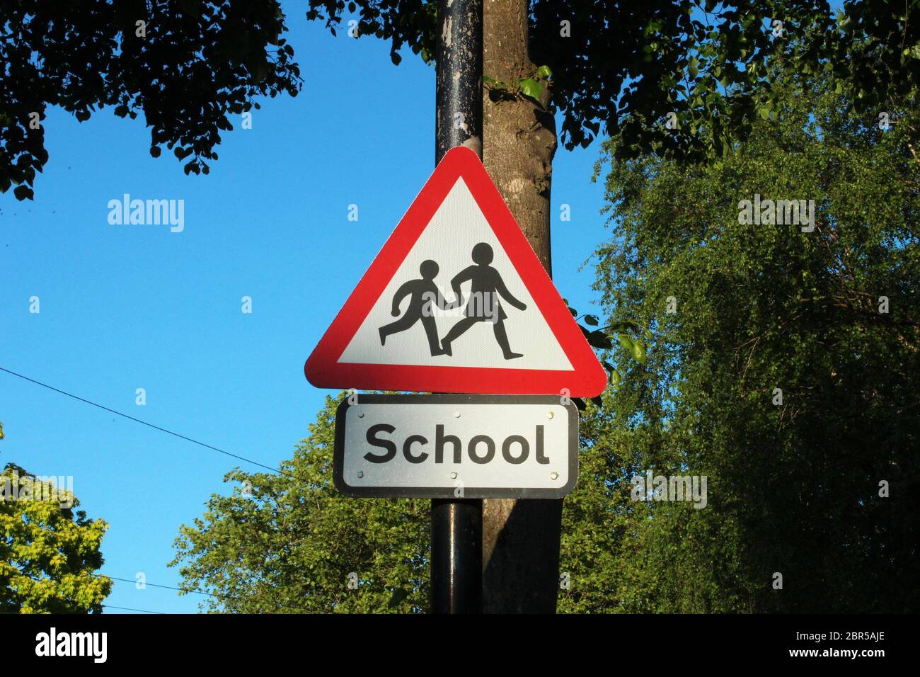Red triangle 'School' sign on a clear day in Manchester, England Stock Photo
