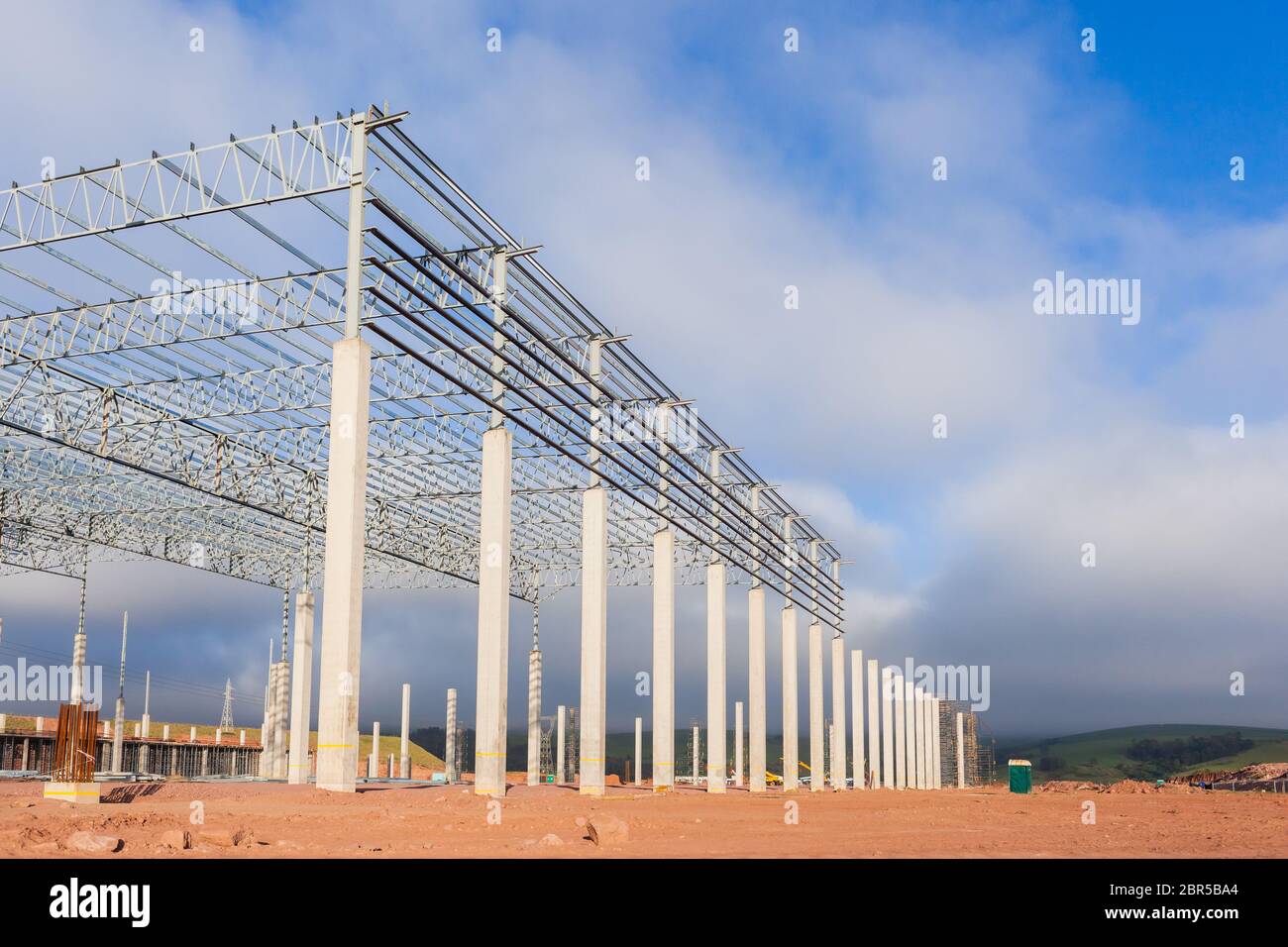 Building new large warehouse construction halfway concrete columns