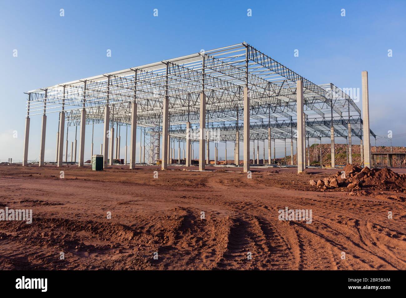 Building new large warehouse construction halfway concrete columns
