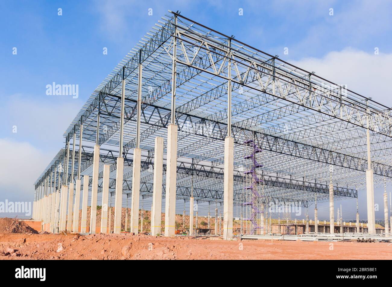 Building new large warehouse construction halfway concrete columns