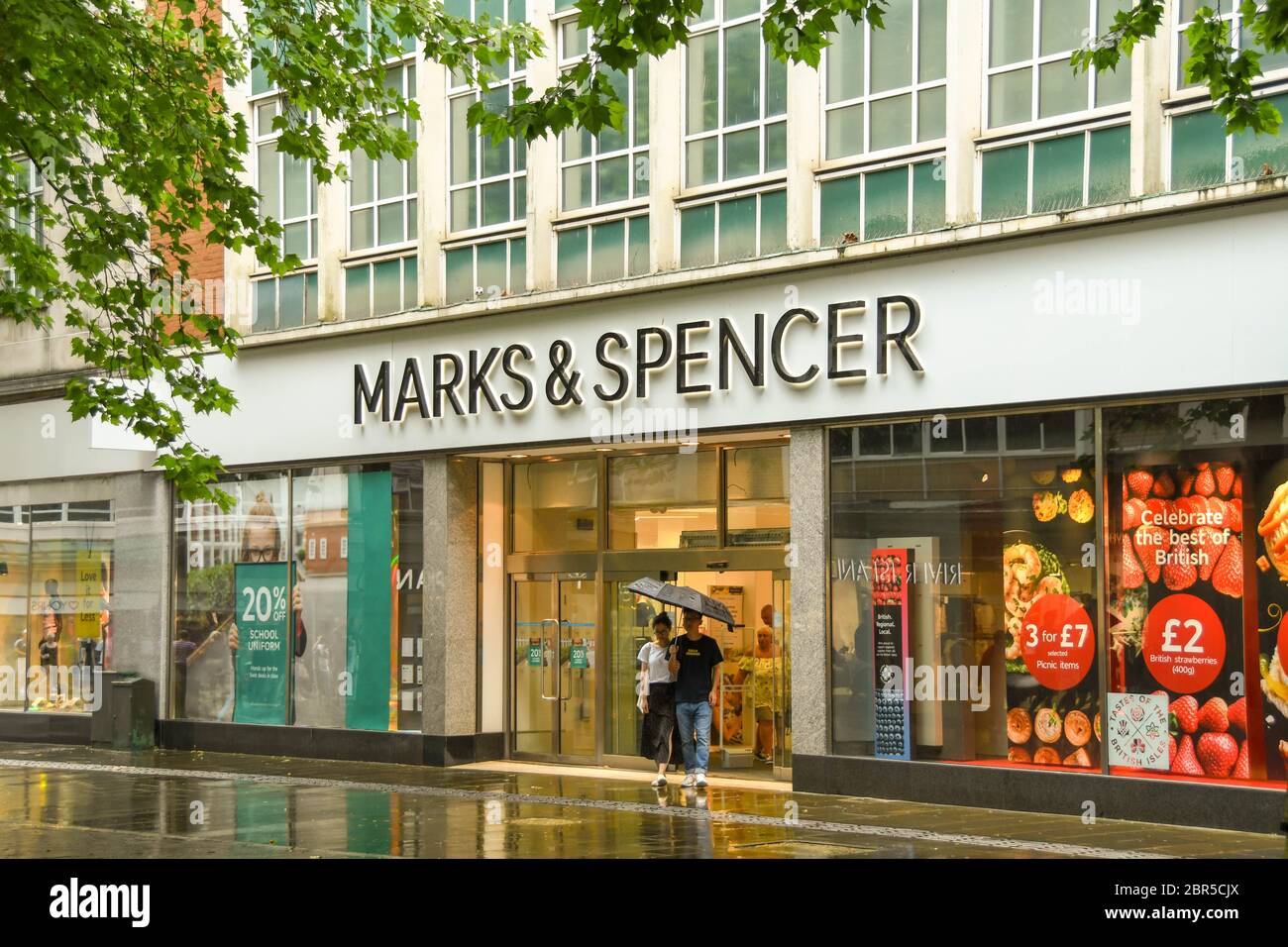 SWANSEA, WALES - JULY 2018: Sign above the entrance to a branch of Marks & Spencer in Swansea city centre. There are reflections on the wet ground Stock Photo