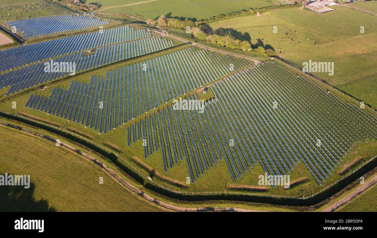 Photovoltaic power station.Solar Farm, solar panels on green fields, farmland, transforming solar light into electricity. Haverfordwest Pembrokeshire. Stock Photo