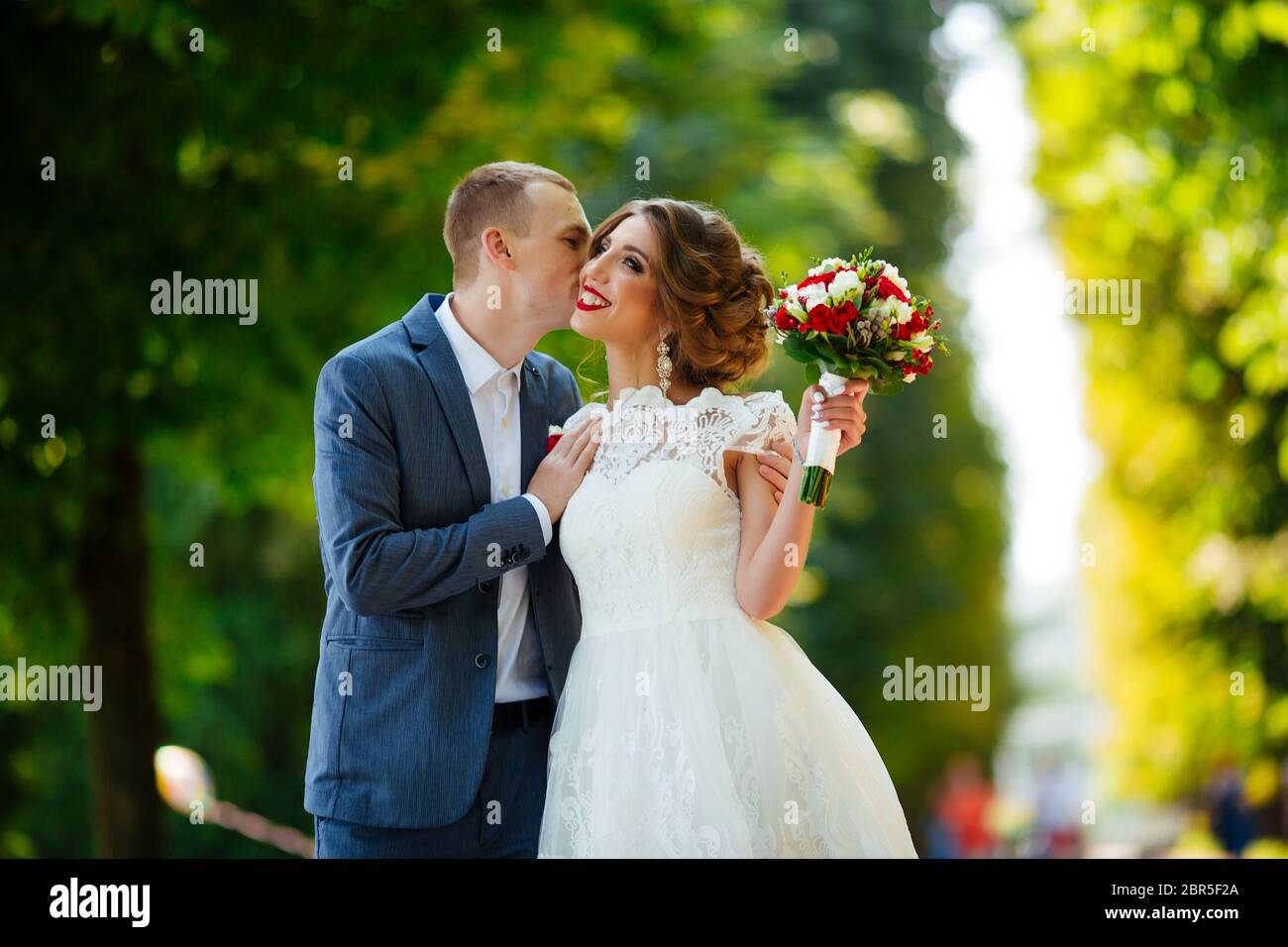 Wedding couple, happy newlyweds and husband hugging in green park Stock ...