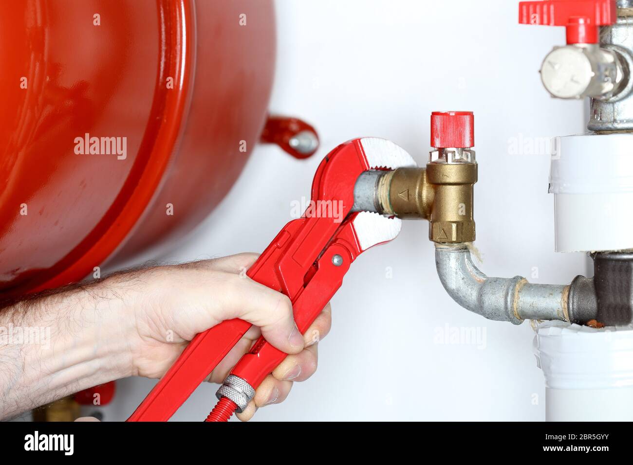 worker with pliers in hand is fixing a problem Stock Photo