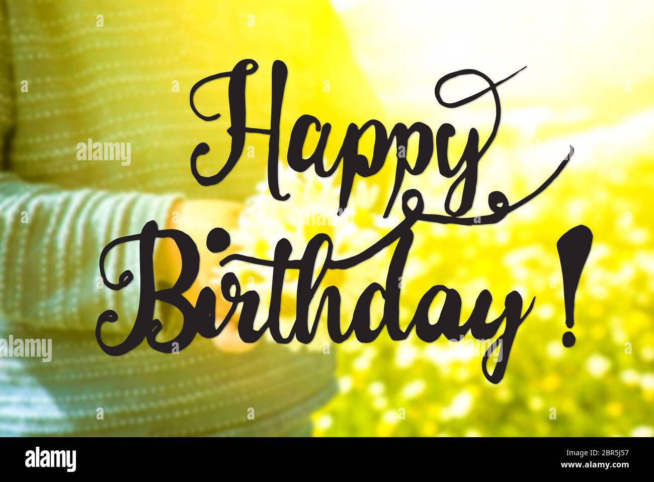 English Calligraphy Happy Birthday Cute Little Kid Is Holding A Bouquet Of Daisy Flower Sunny And Spring Flower Field Stock Photo Alamy