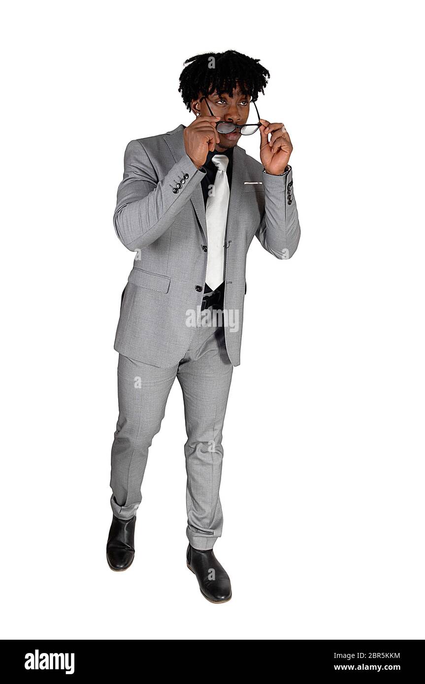 An African American young man standing in a gray suit, with his ...