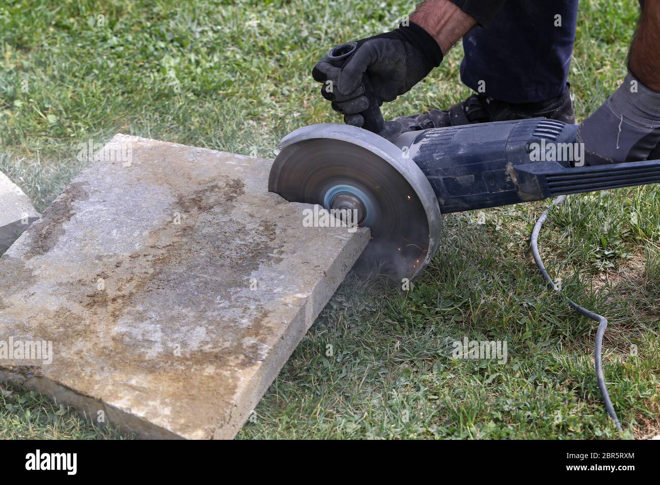 Industrial construction worker using a professional angle grinder Stock Photo