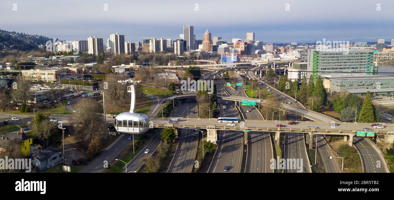 The cable car is full of riders exploring Portland via aerial trensportation Stock Photo