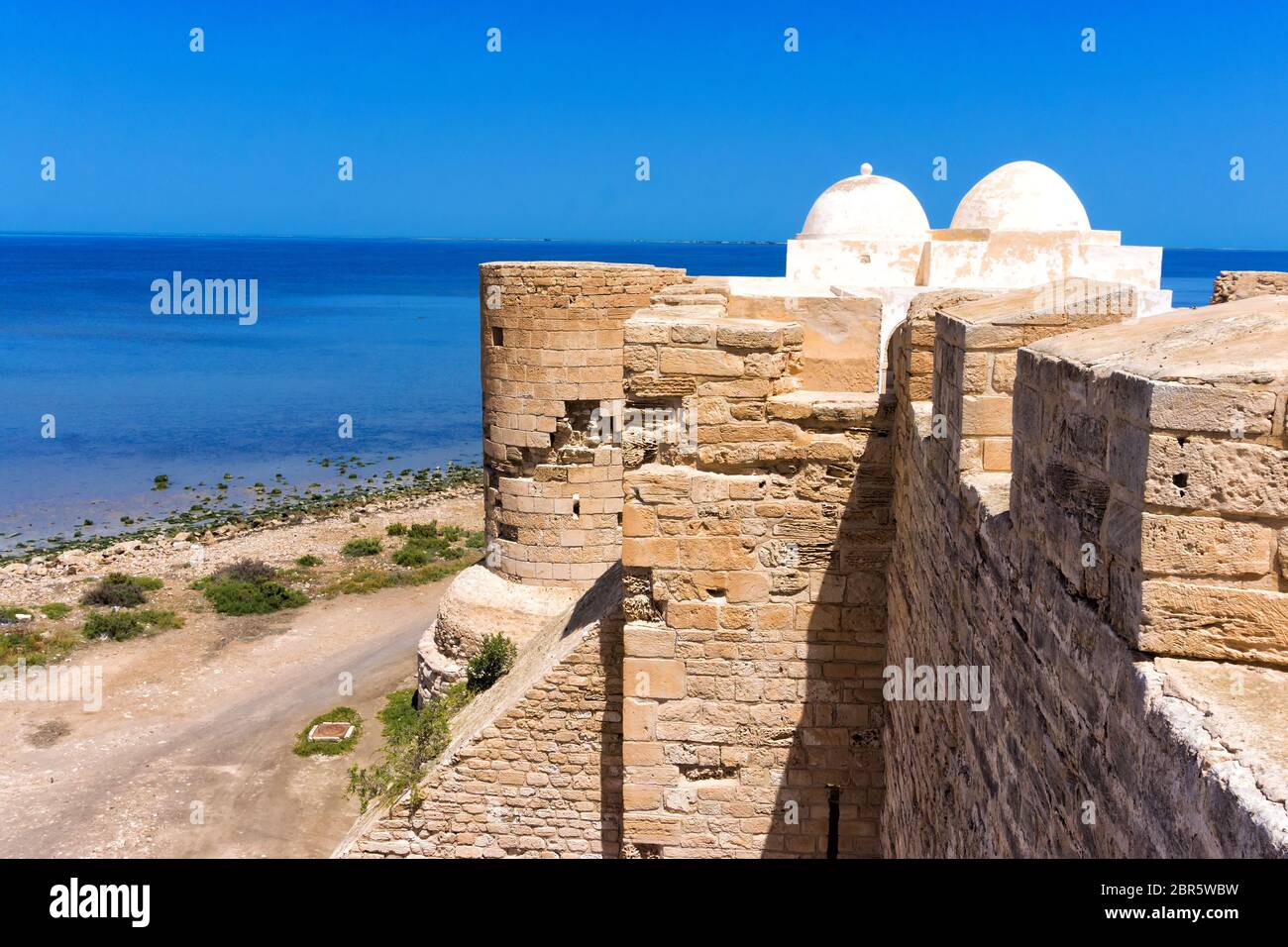 Tower of the Borj el Kebir Castle with background of Mediterranean sea in Houmt El Souk in