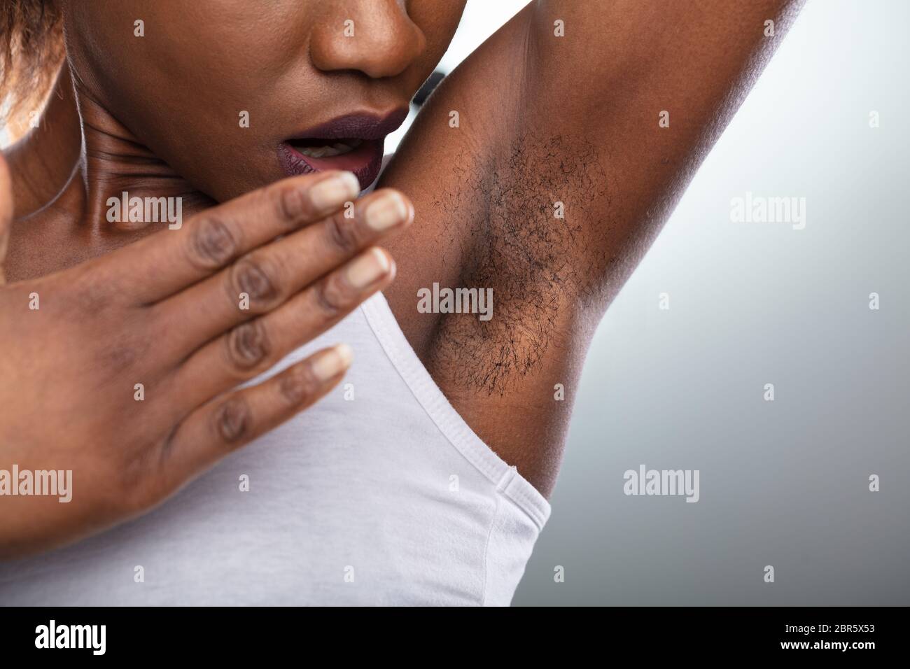Close-up Of A Young Woman With Hairy Armpit Stock Photo