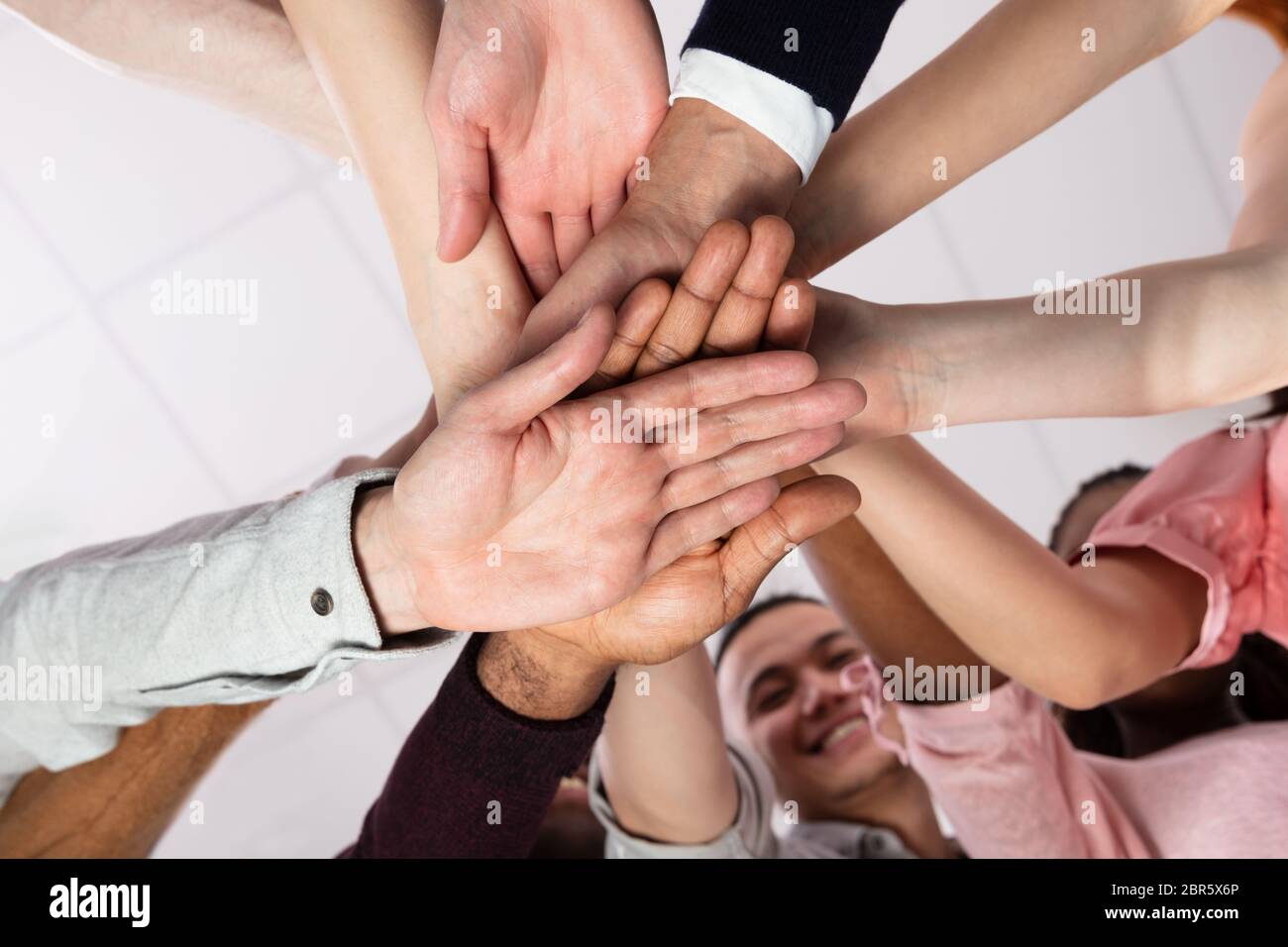 Multi-ethnic Group Of People Stacking Hand Showing Unity Stock Photo