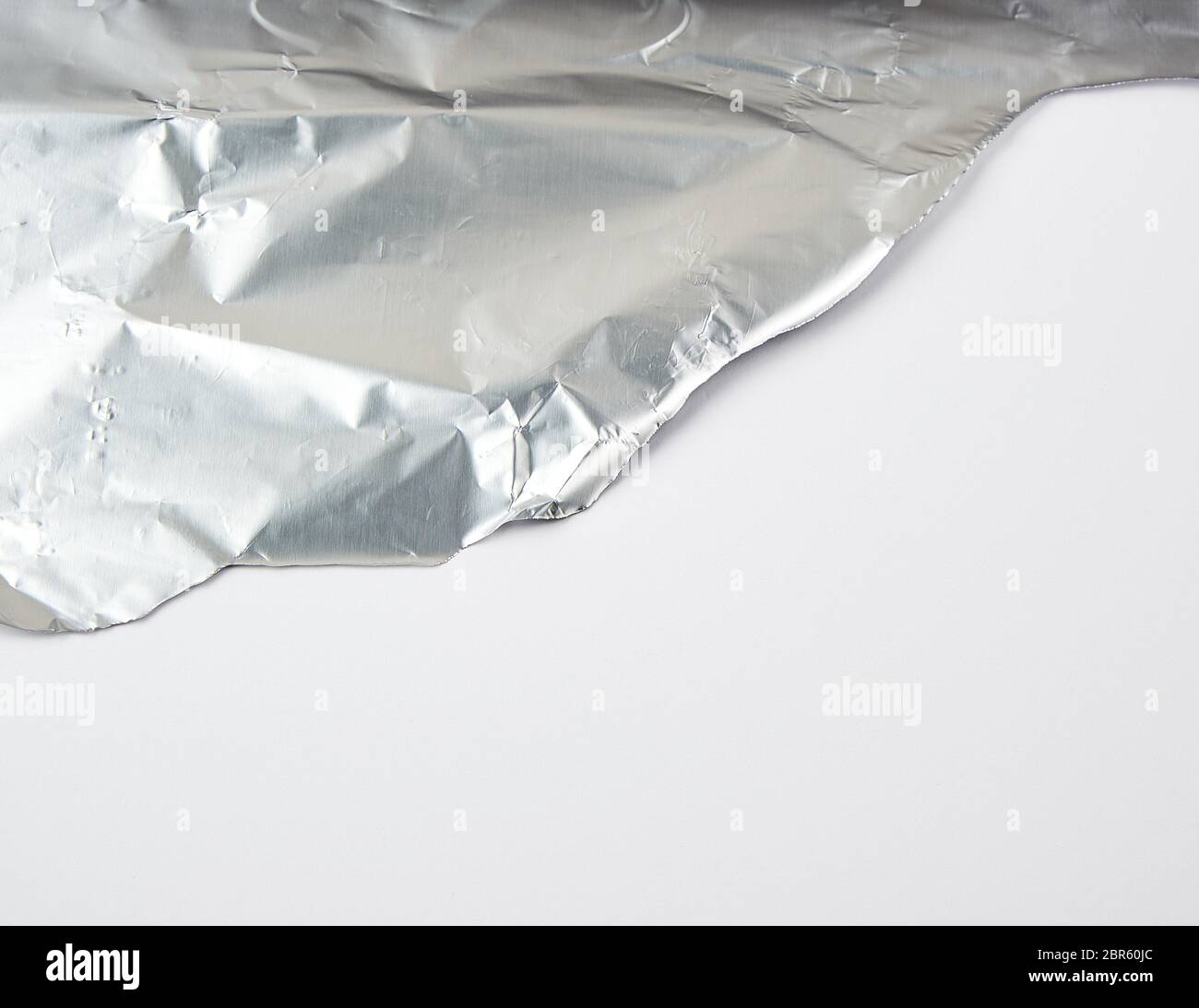 White Riggid Edge ragged edge of silver foil ra white background, close up Stock Photo ...