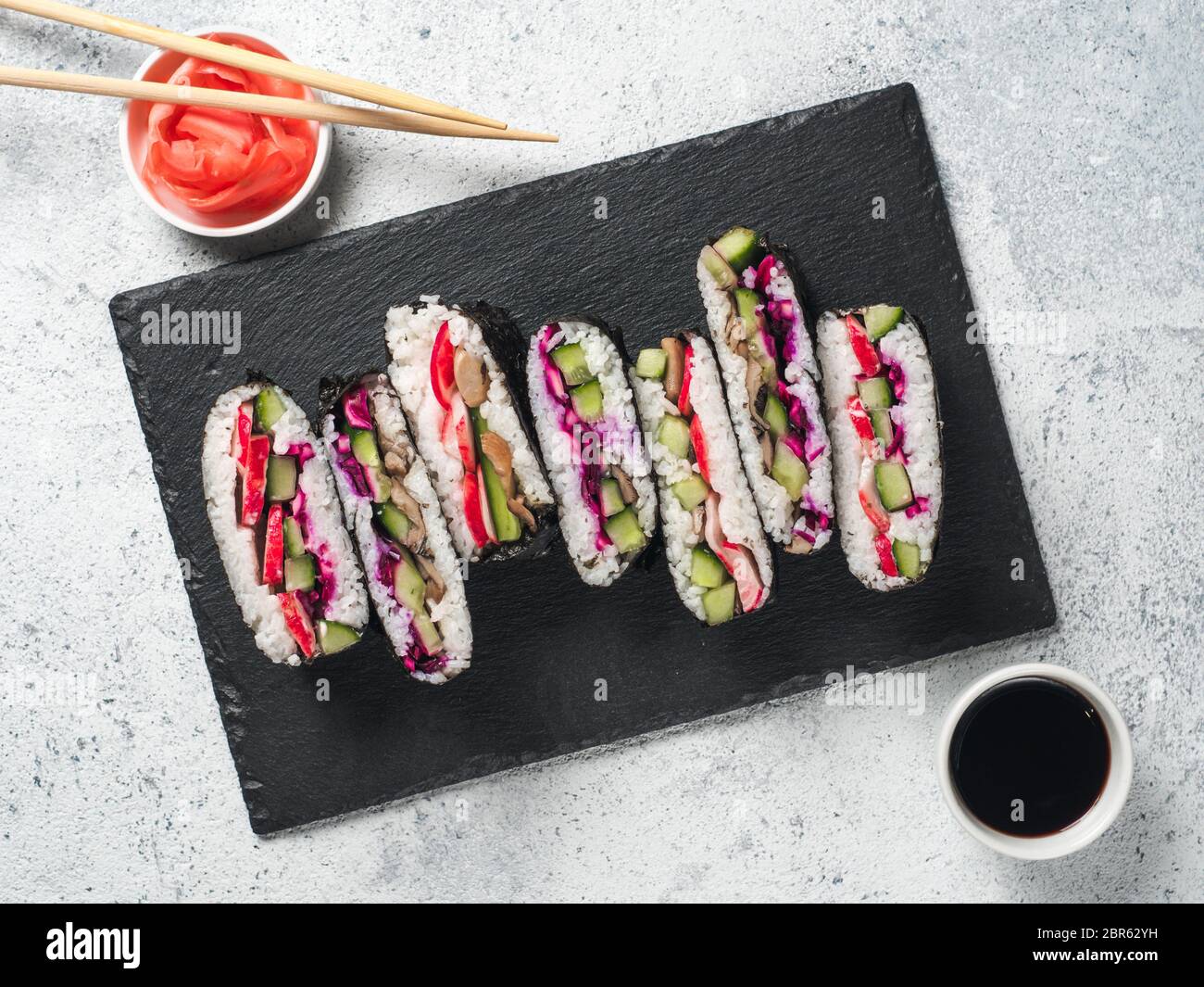 Vegan sushi sandwich onigirazu with mushrooms and vegetables. Healthy dinner recipe and idea. Colorful japan sandwich onigirazu with red cabbage,radis Stock Photo