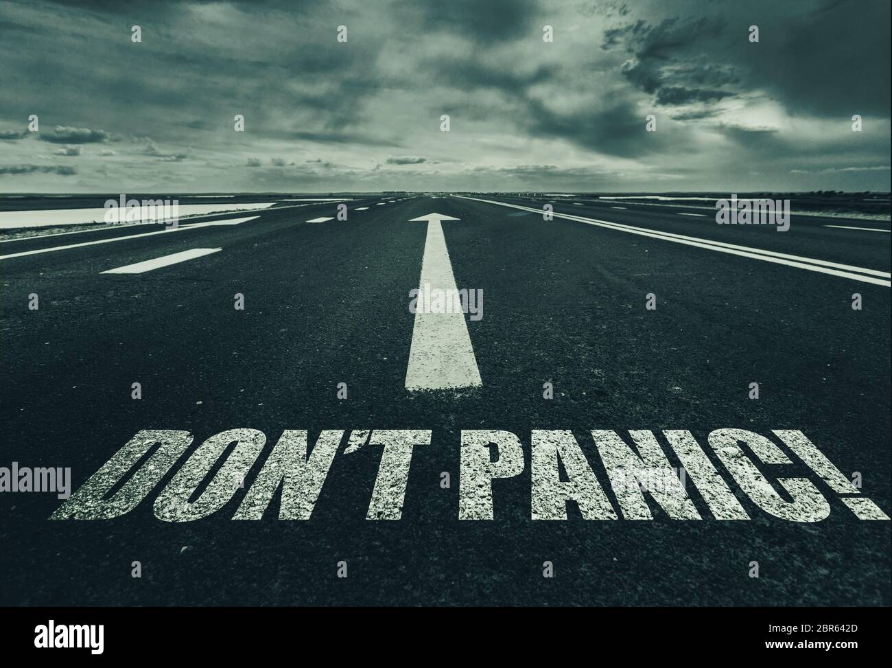 Dont Panic written on the road Stock Photo