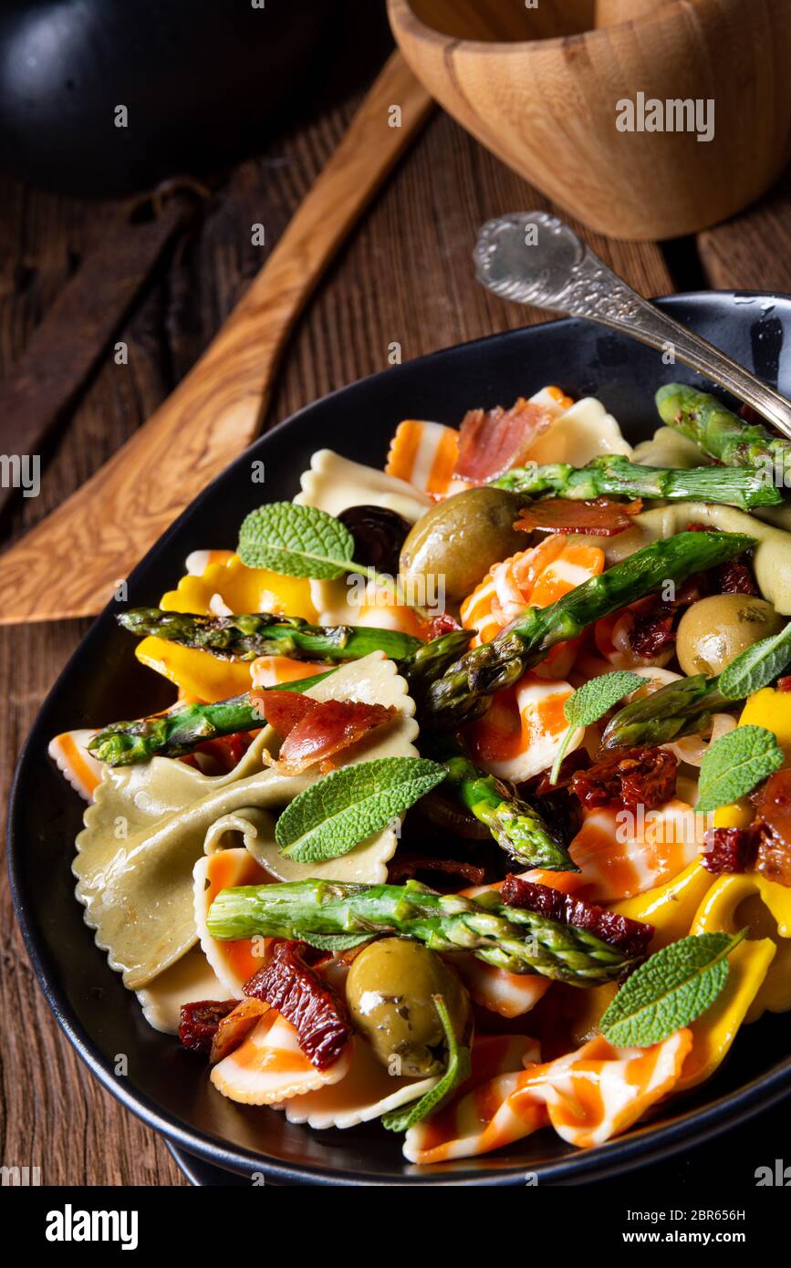 Pasta salad with green asparagus, olives and parma ham Stock Photo Alamy