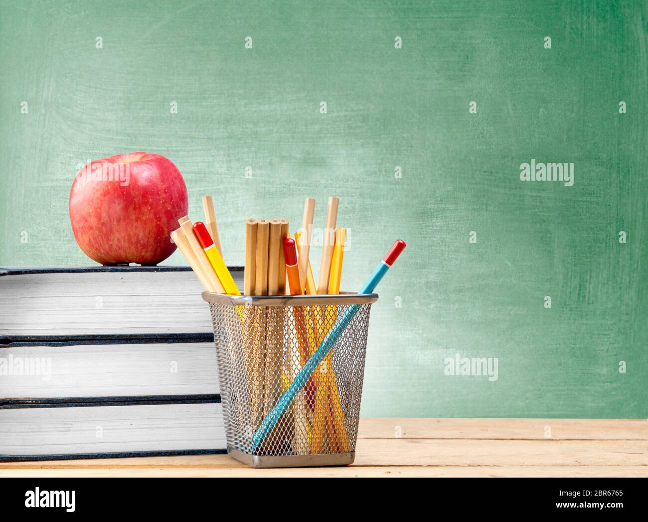 School objects for students. Chalkboard, pencils, crayons and apple Stock  Photo - Alamy