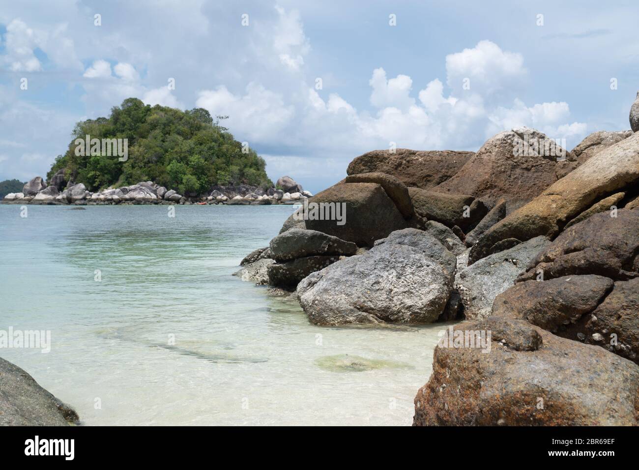 Sandy beach with rocks over sea and cloudy sky. Koh Lipe island in ...