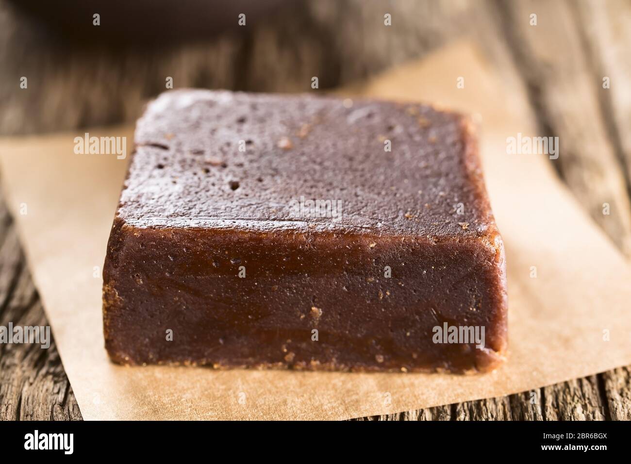 Block of chancaca or panela raw unrefined sugar made of sugarcane, used in Latin America to prepare sweet sauces and other sweets (Selective Focus, Fo Stock Photo