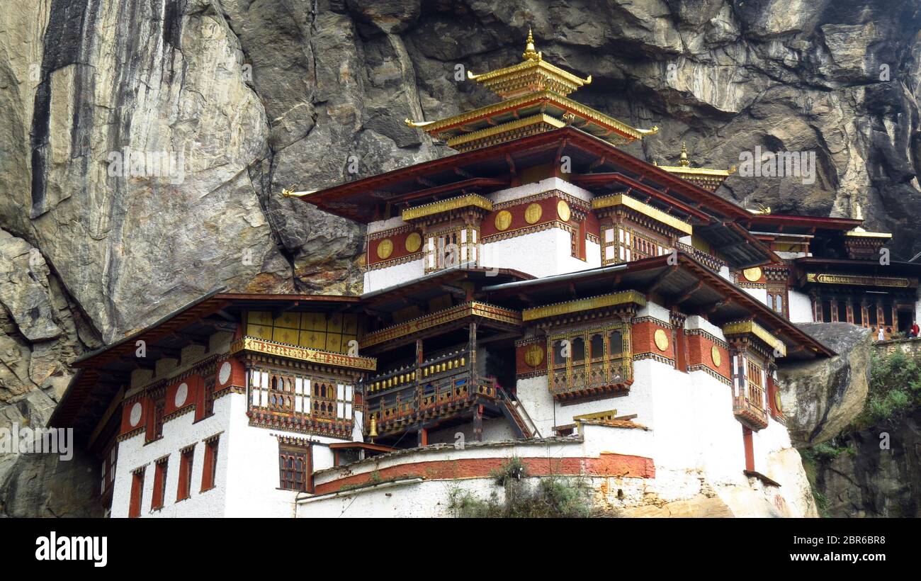 A closeup view of the entire Tigers Nest Monastery built in a high cliff over the valley in Paro, Bhutan Stock Photo