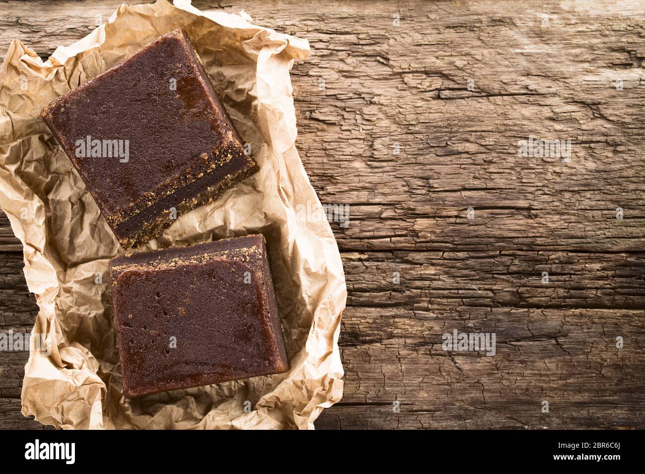 Blocks of chancaca or panela raw unrefined sugar made of sugarcane, used in Latin America to prepare sweet sauces and other sweets, photographed overh Stock Photo