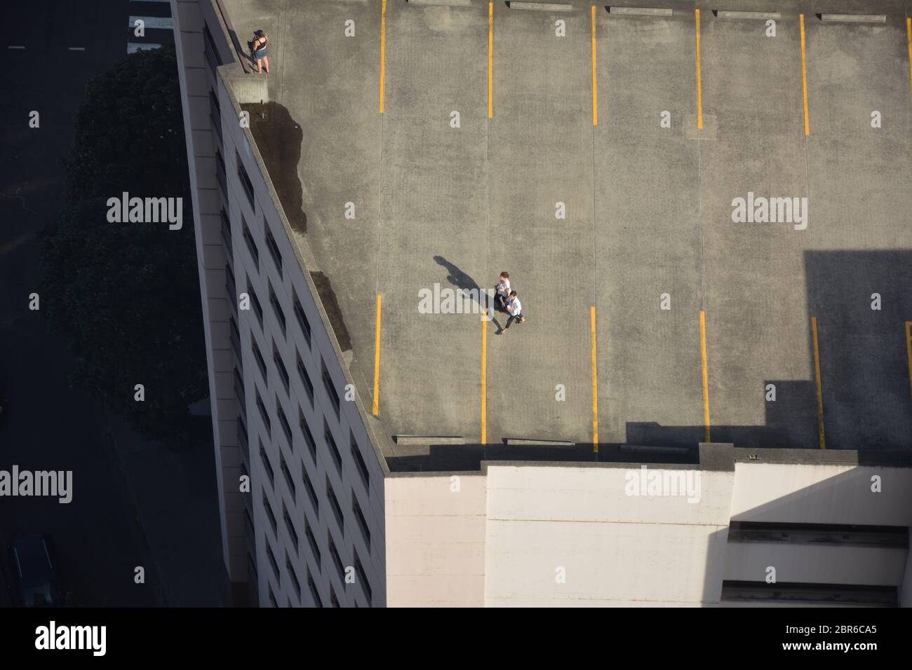 Aerial view of people on the open rooftop of a parking garage in