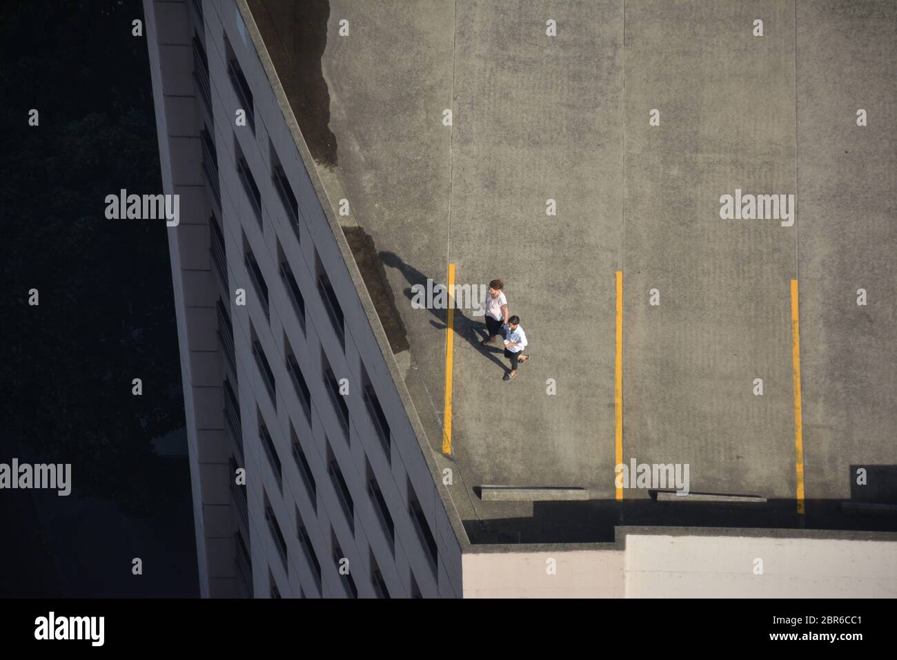 Aerial view of people on the open rooftop of a parking garage in