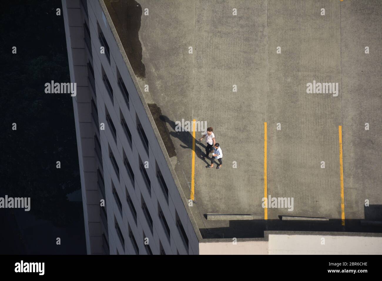 Aerial view of people on the open rooftop of a parking garage in