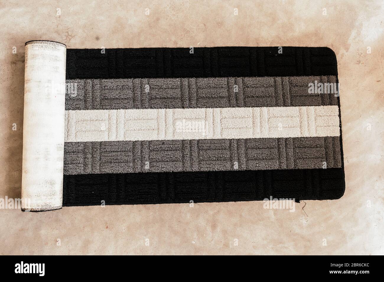 Yoga mat black white and grey color striped design on floor background