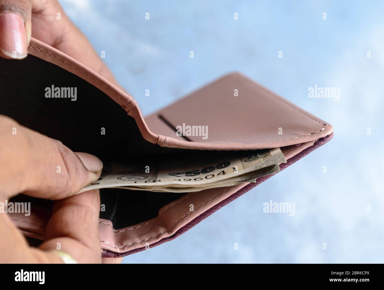 Businessman putting or taking out or paying Indian rupee banknotes from leather wallet. Isolated white background. Earning crisis growth bribe corrupt Stock Photo