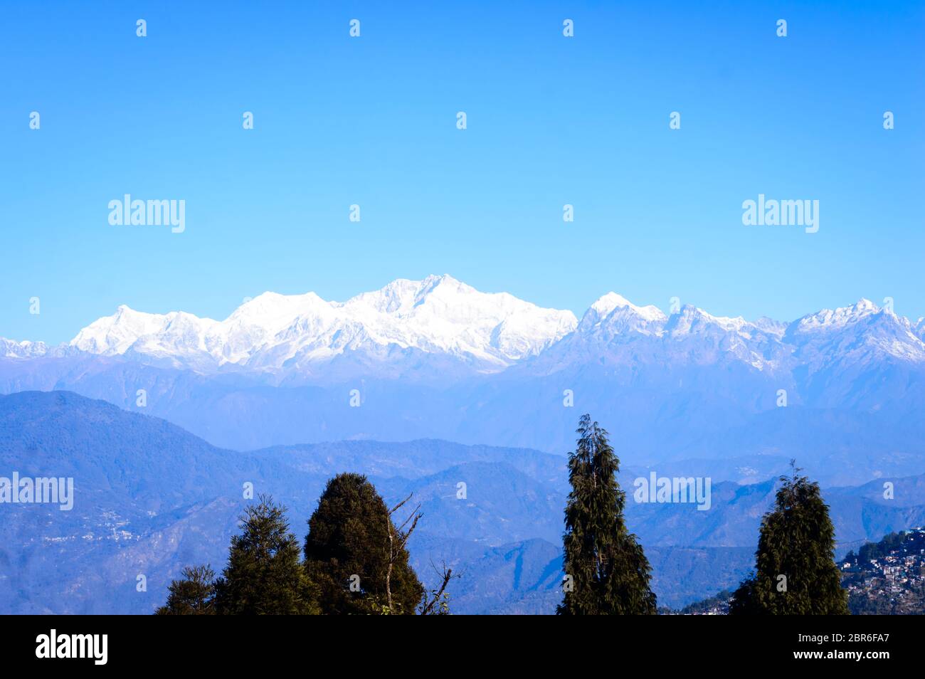 View of Himalaya, the Kanchenjunga mountain range, morning sunrise falling over the peak, from 'Dzongri' pass sikkim on a sunny day in clear bule sky. Stock Photo