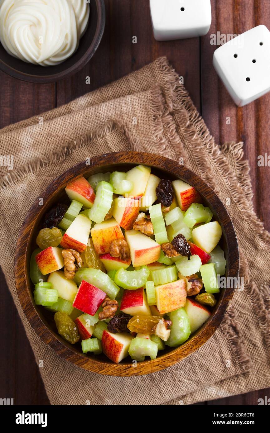 Fresh Waldorf salad made of celery, apple, walnuts, sultanas and