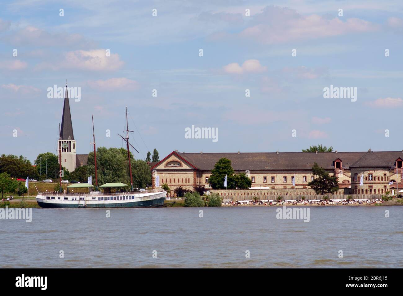 The banks and the promenade along the river Rhine in Mainz Kastel with the Kasteler beach and the beach boat as well as the St. George church in the b Stock Photo